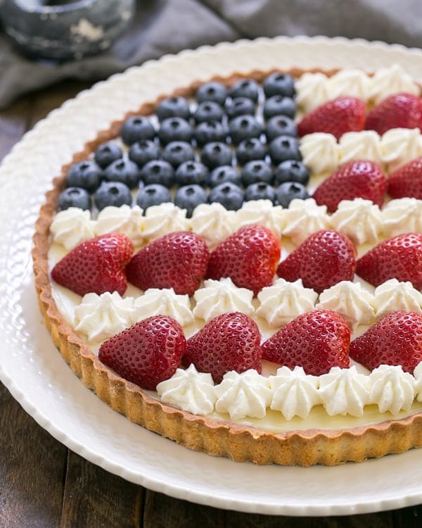 American Flag Fruit Tart on a white ceramic plate.