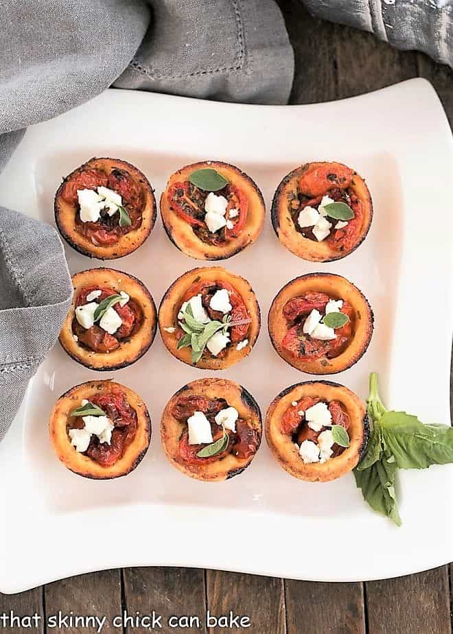 Cheese Straw Tomato Tartlets on a white serving tray.