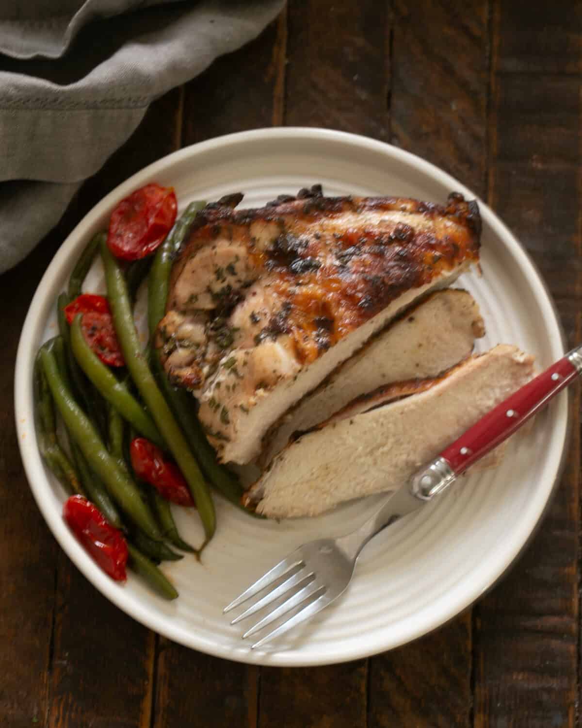 Easy Chicken Piccata Recipe on a dinner plate with a fork.