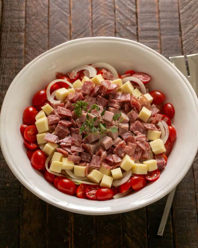 Overhead view of chopped salad in a white serving bowl.