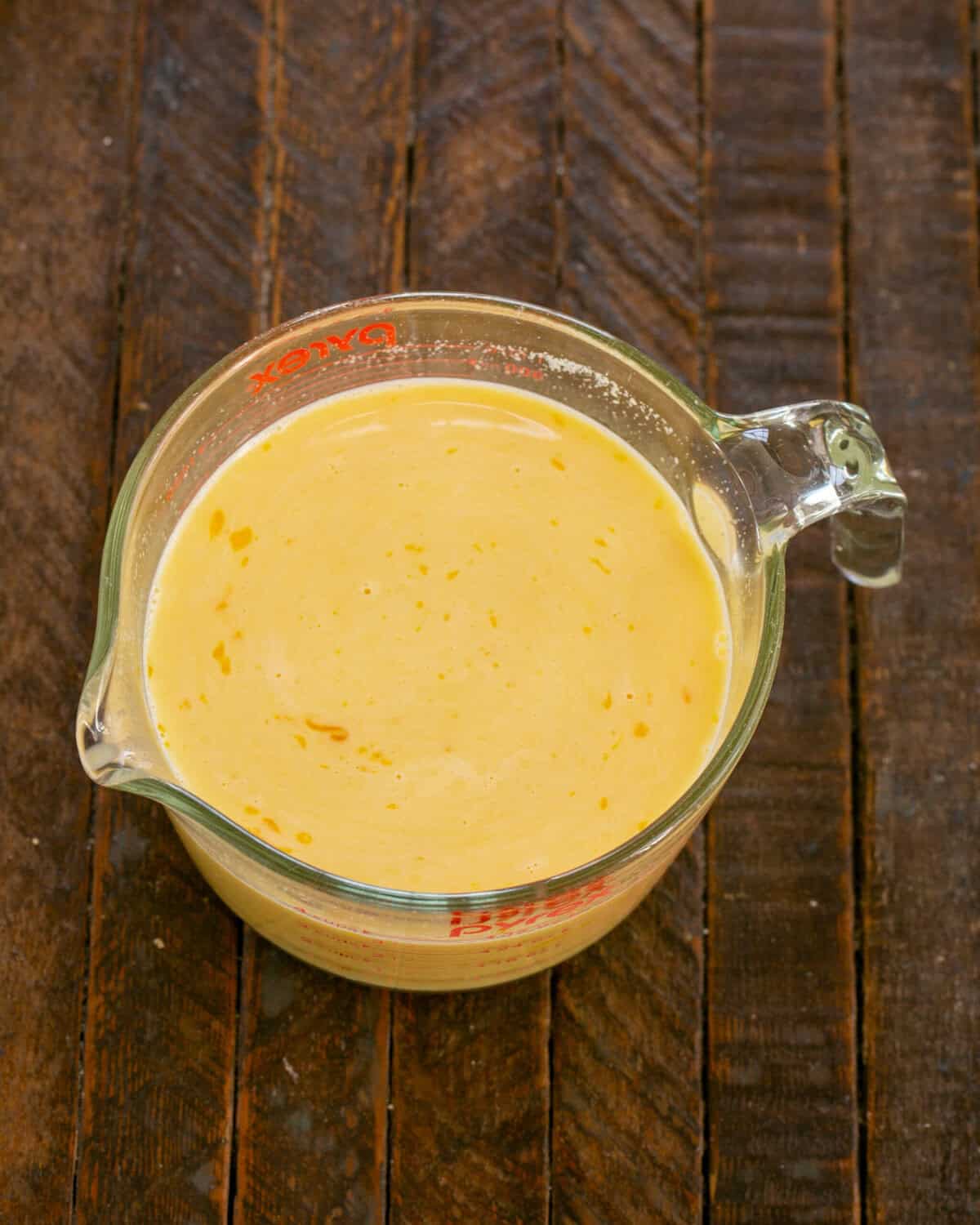 Beaten eggs, milk, dried mustard and salt in a Pyrex measuring cup.