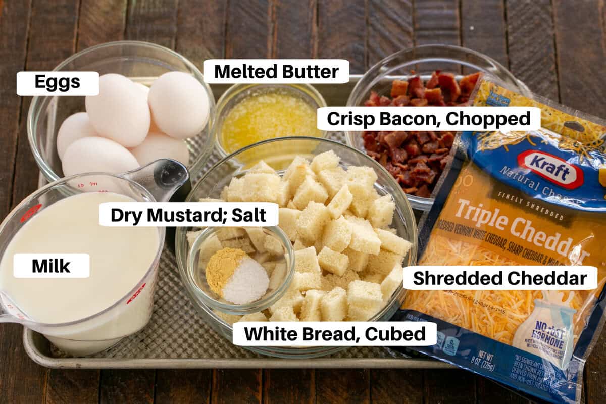 Overnight breakfast casserole ingredients on a sheet pan with labels.